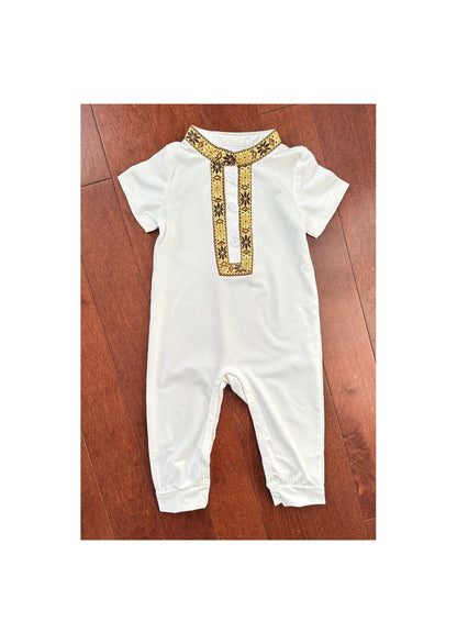 Combinaison traditionnelle blanche pour bébé, ornée d'un col et d'une patte de boutonnage brodés en doré et marron.

