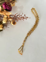 Tasbih musulman en perles de cristal dorées, 33 billes, séparateurs métalliques, cordon tressé or, fond floral décoratif